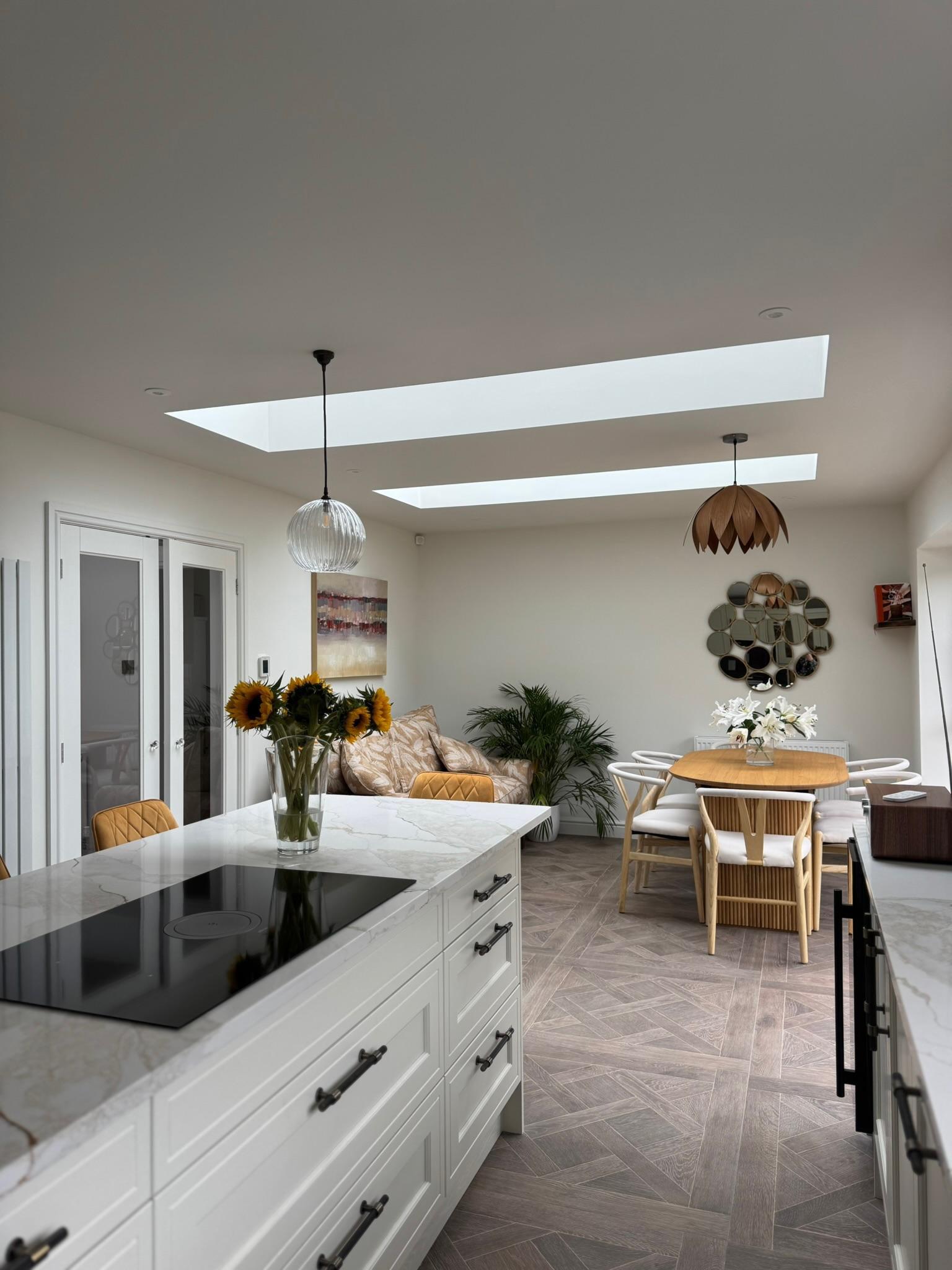 Kitchen-diner with skylights, marble island and sunflowers